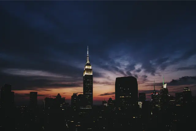 The Empire State Building against a deep blue and orange dusk sky, in DSTY G 800