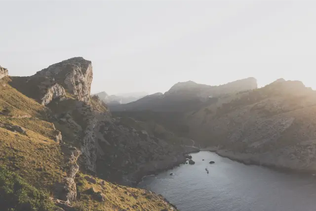 Sunlit cliffs above a narrow bay on Mallorca, in Fuji Pro 400H