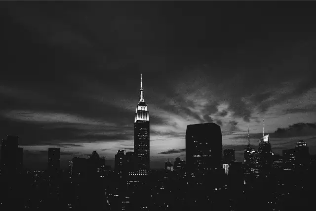 The Empire State Building against a deep blue and orange dusk sky, in Ilford Delta 3200