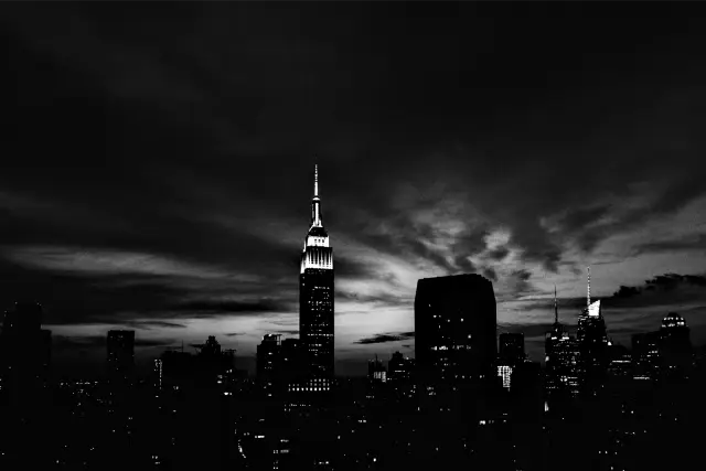 The Empire State Building against a deep blue and orange dusk sky, in Kodak Tri-X 400