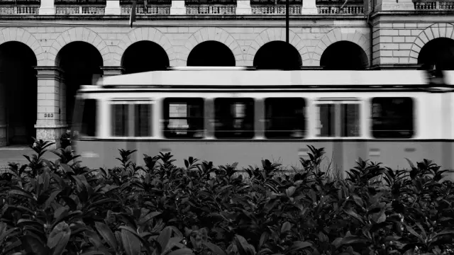 A yellow tram passing a stone arcade in Budapest, in Kodak Tri-X 400