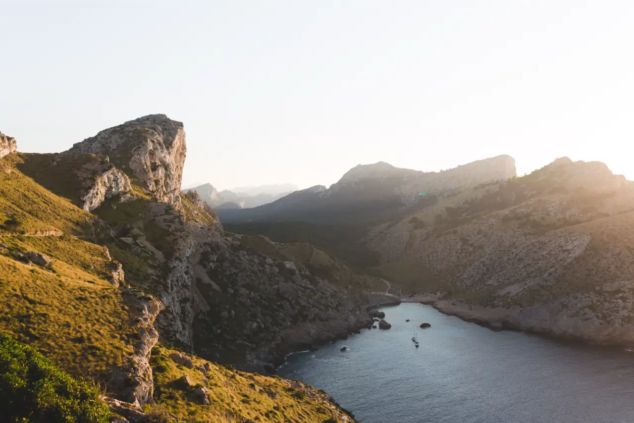Sunlit cliffs above a narrow bay on Mallorca, unedited