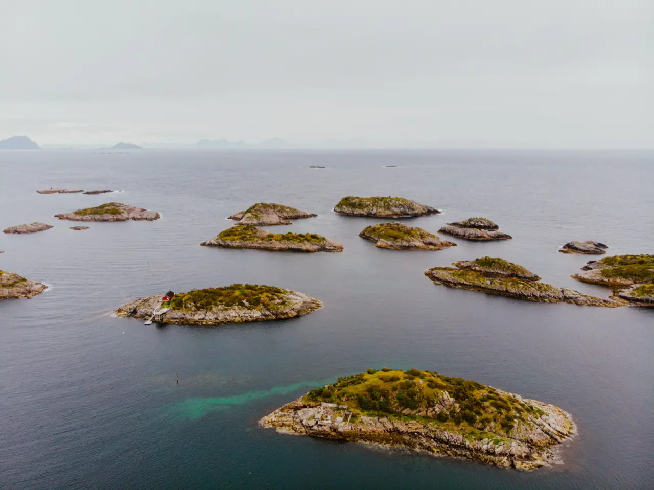 Small rocky islands scattered across the sea in Lofoten, seen from above, unedited