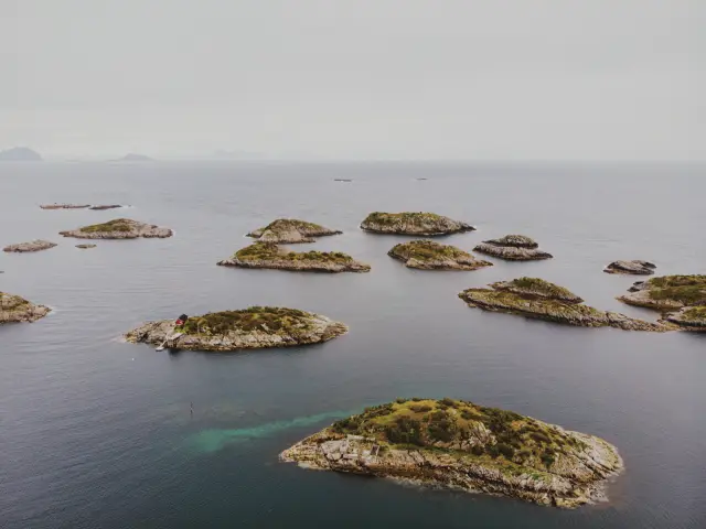 Small rocky islands scattered across the sea in Lofoten, seen from above, in Pro Neg Hi