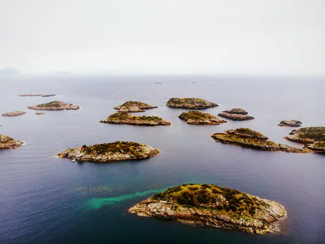 Small rocky islands scattered across the sea in Lofoten, seen from above, in NEO v 90
